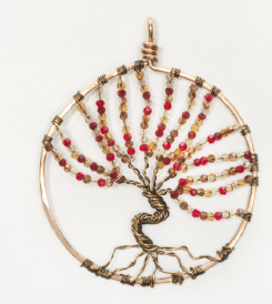A Tree of Life pendant featuring a  brass  wire frame with an array of multicolored gemstones arranged in a circular pattern to form the design of a tree. on a white background, front view.