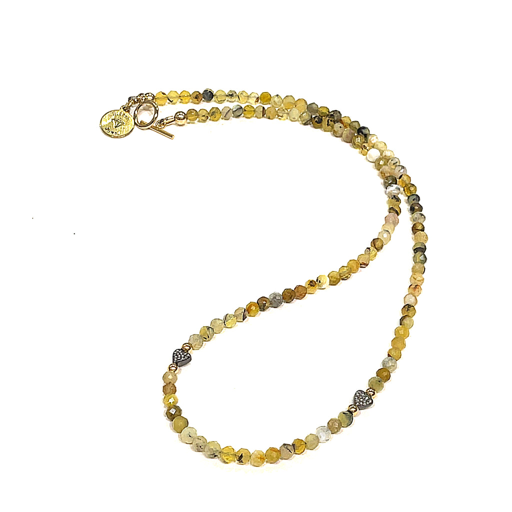 A Yellow Opal gemstone necklace with diamond pave hearts placed on a white background front long view.