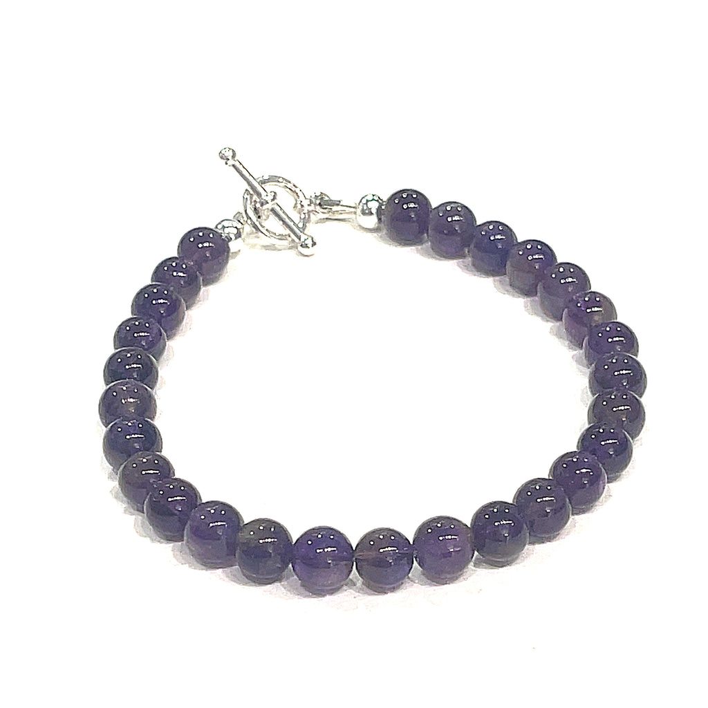 A beaded Amethyst gemstone bracelets, displayed against a white background, front close up overview. 