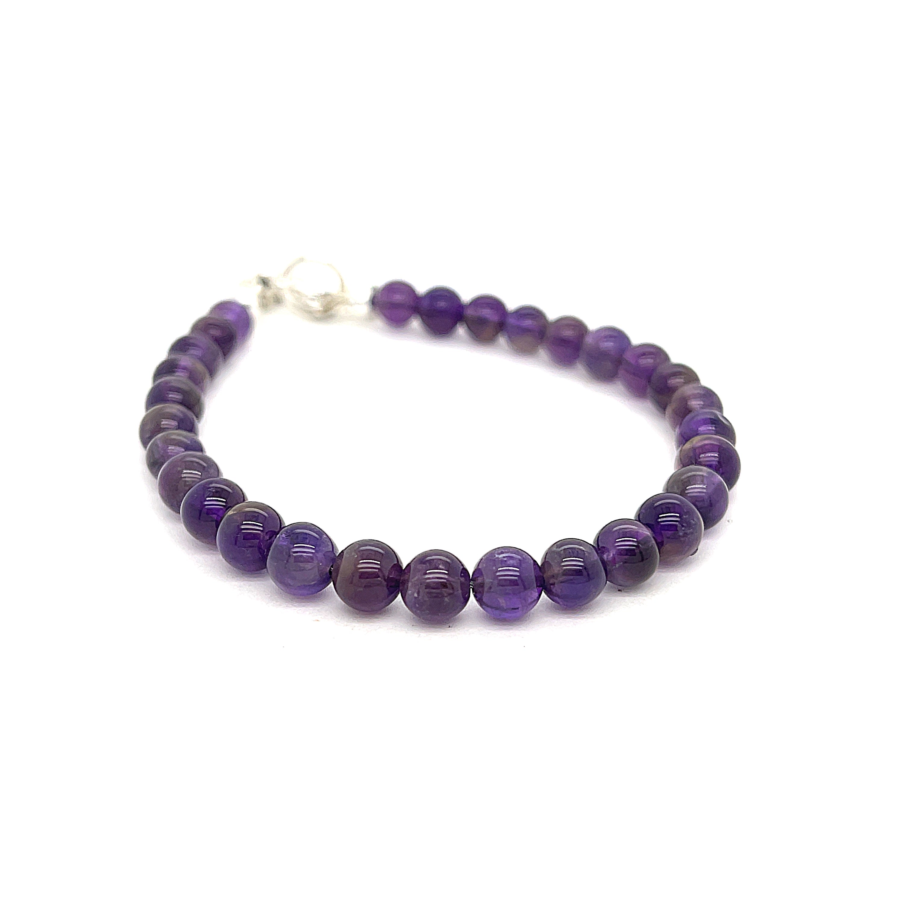 A beaded Amethyst gemstone bracelets, displayed against a white background, front slight right angel overview. 