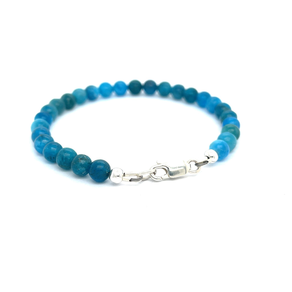 A blue Apatite beaded gemstone bracelet with silver lobster claws, displayed against a white background, back center overview.
