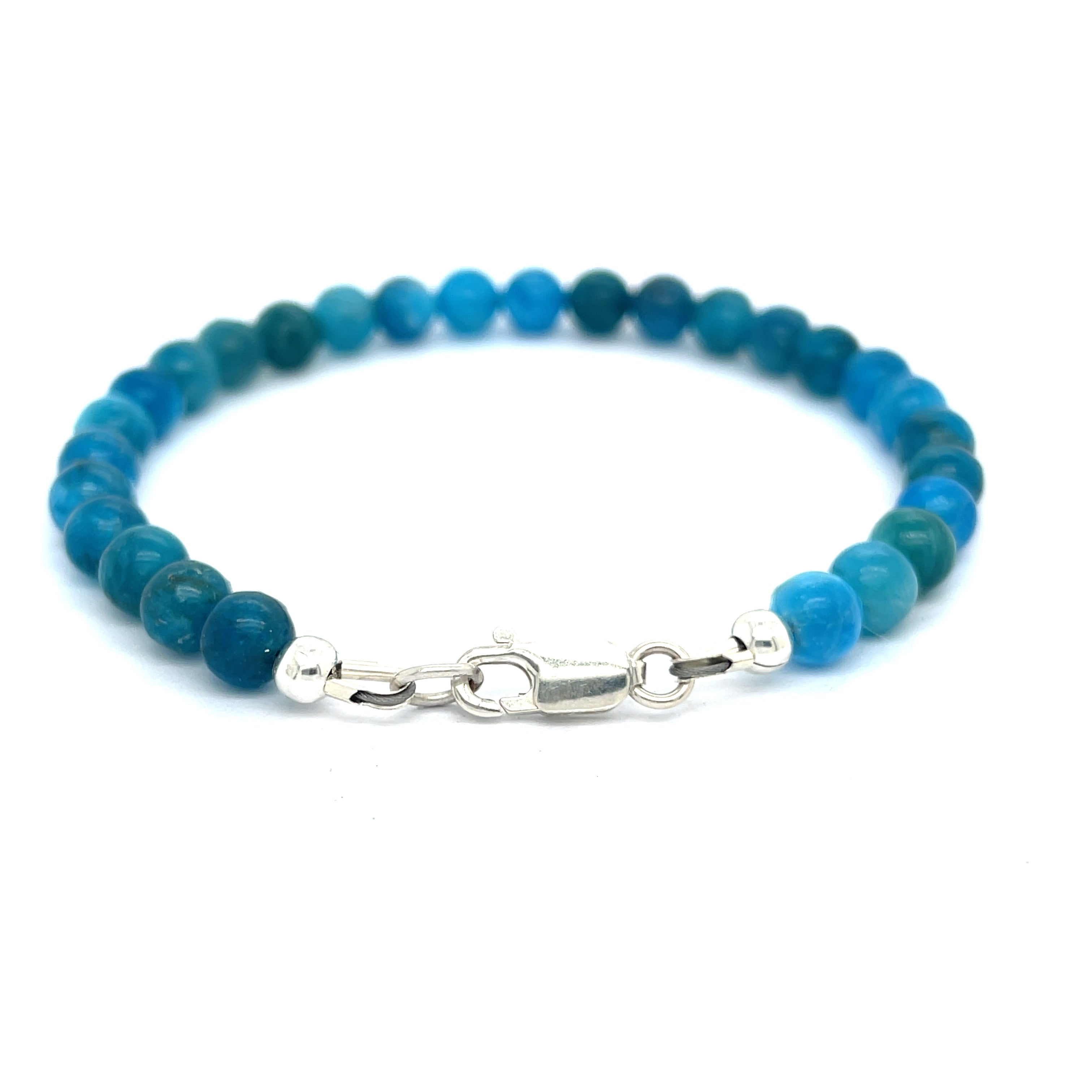 A blue Apatite beaded gemstone bracelet with silver lobster claws, displayed against a white background, back overview.