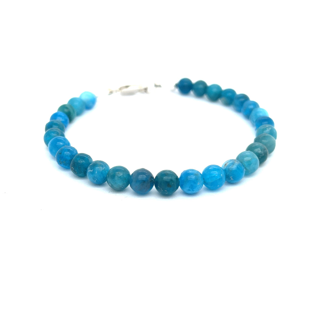 A blue Apatite beaded gemstone bracelet with silver lobster claws, displayed against a white background, front center overview.