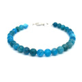 A blue Apatite beaded gemstone bracelet with silver lobster claws, displayed against a white background, front overview.