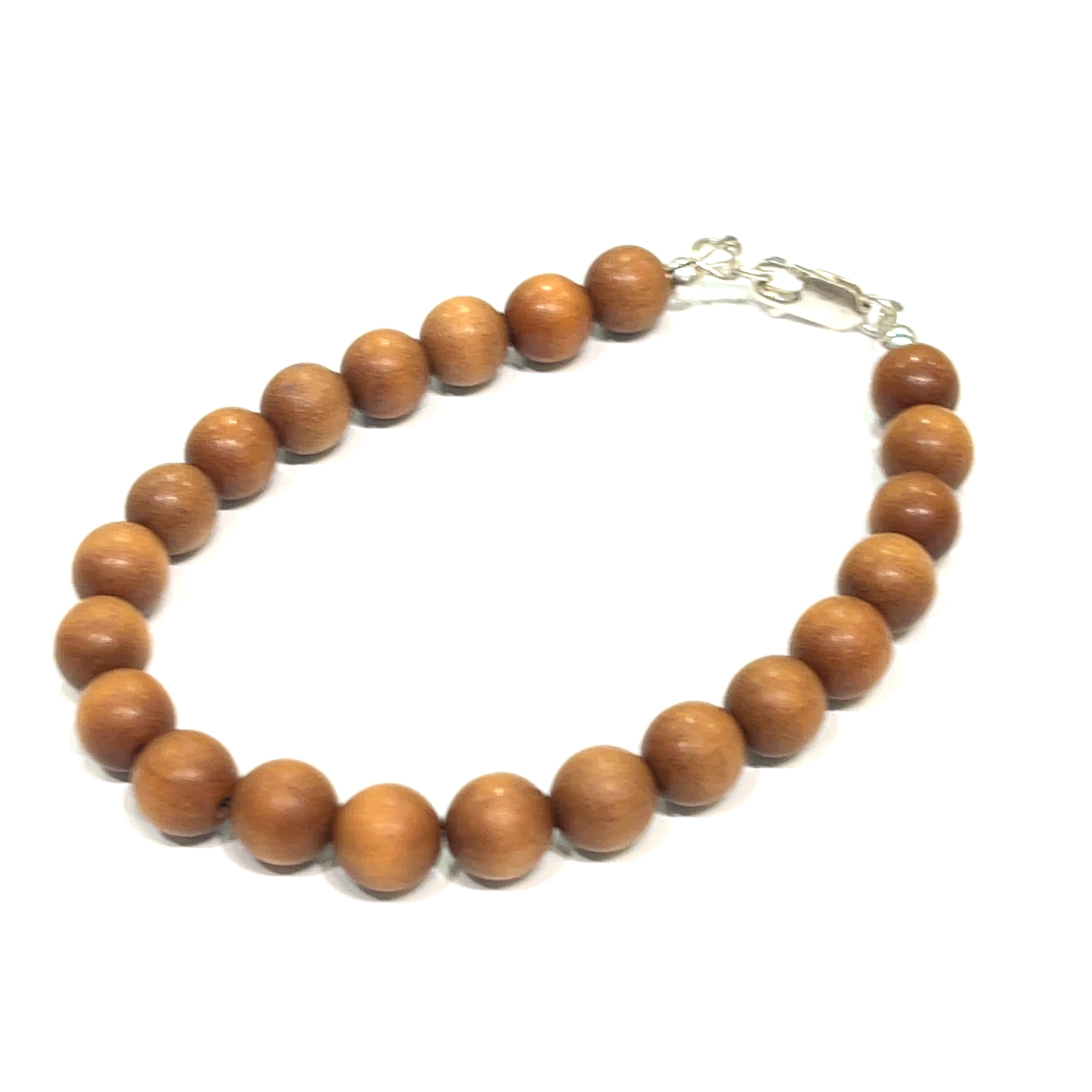 A brown sandalwood beaded bracelet with a sterling silver lobster-claw clasp on a white background, front left angle overview.