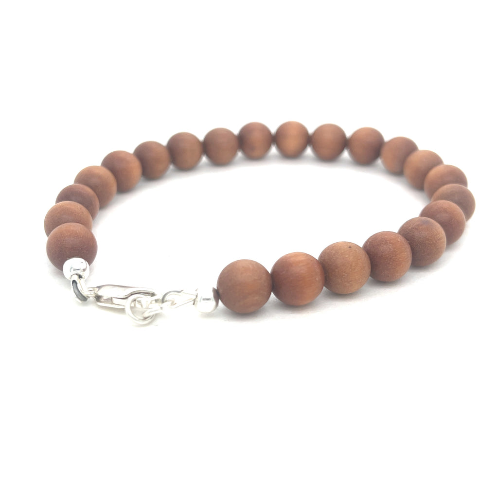 A brown sandalwood beaded bracelet with a sterling silver lobster-claw clasp on a white background, left back side overview.