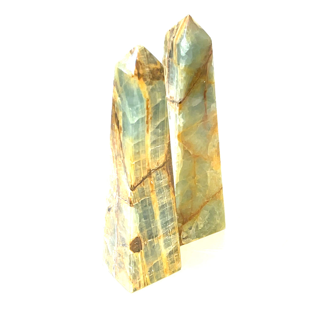 A collection of 3XL large sizes of  blue onyx gemstone towers displayed in a group on a white background, front overview.