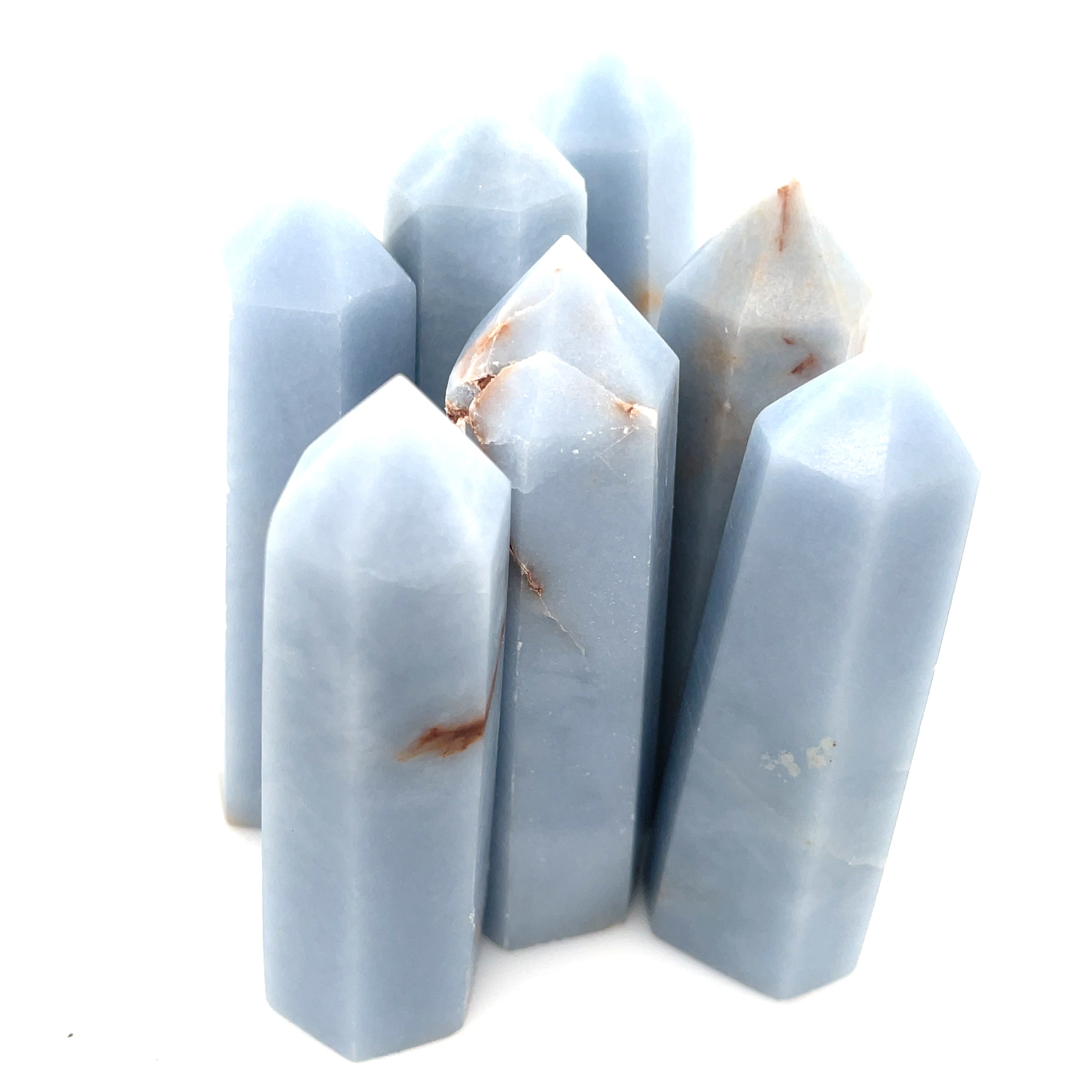 A collection of Angelite gemstone towers displayed together on a white background front, center overview. 
