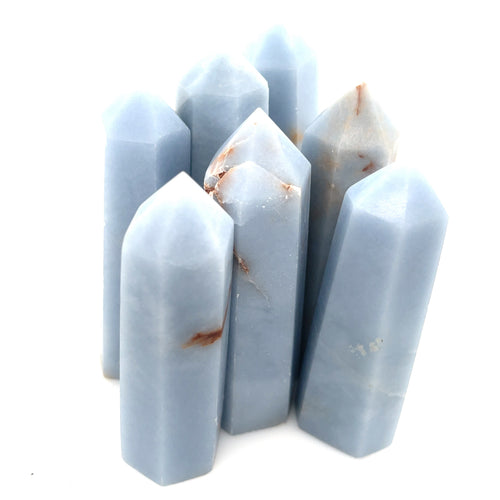 A collection of Angelite gemstone towers displayed together on a white background front, center overview. 