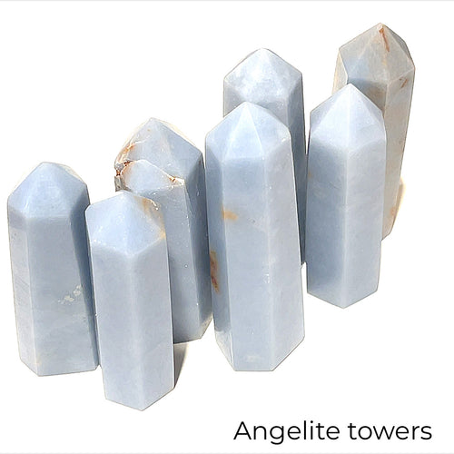 A collection of Angelite gemstone towers displayed together on a white background front overview. 