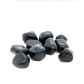 A collection of Apache Tear tumbled gemstones on a white background, front overview. 