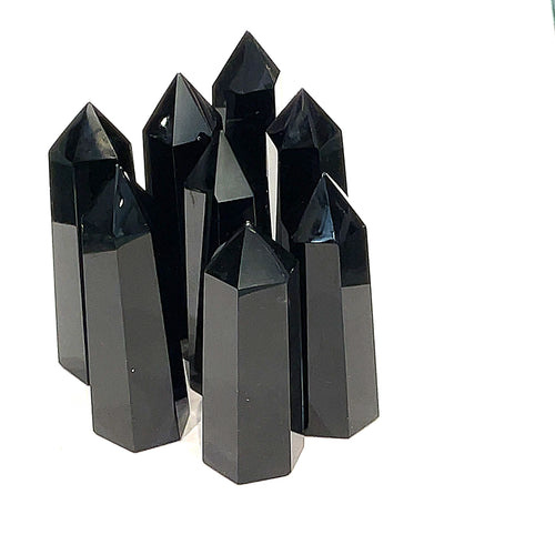 A collection of Black Obsidian Tower gemstones, displayed together on a white background, front close up view. 