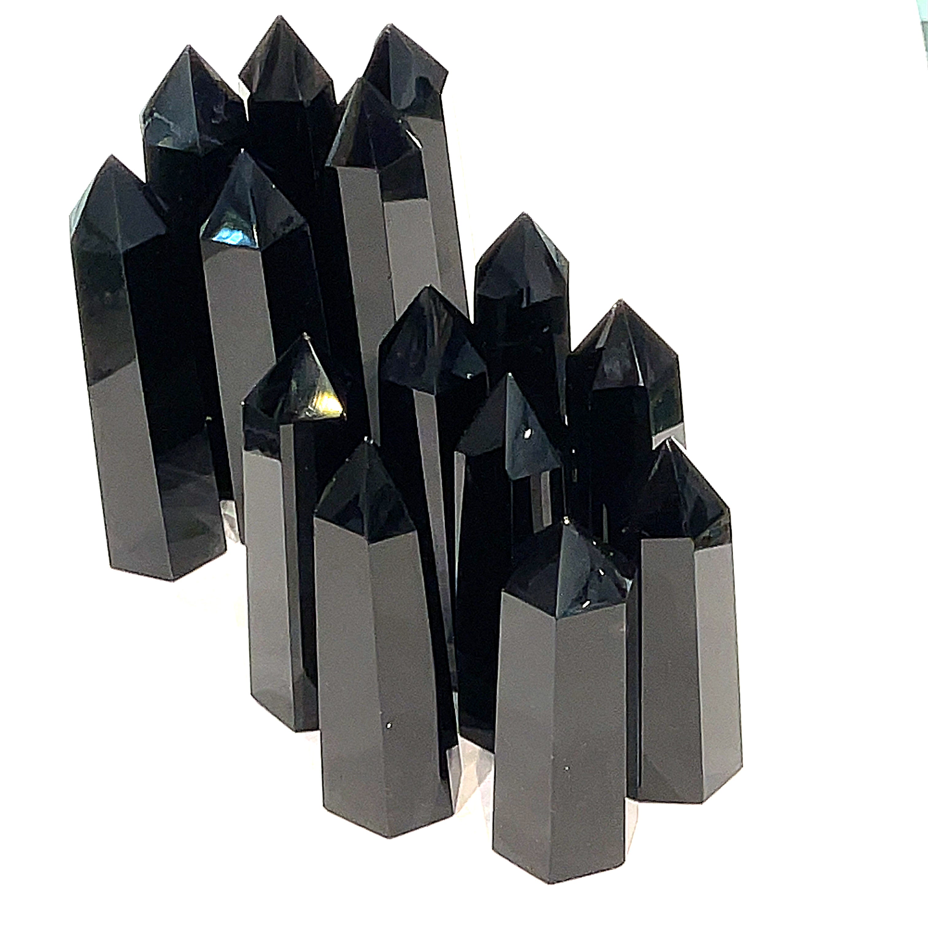 A collection of Black Obsidian Tower gemstones, displayed together on a white background, front view. 