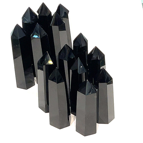 A collection of Black Obsidian Tower gemstones, displayed together on a white background, front view. 