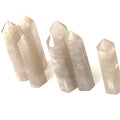 A collection of Blue Rose quartz gemstone towers arranged together against a white background, front overview. 