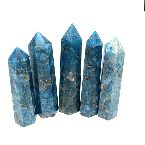 A collection of Five Blue Apatite Gemstone Towers arranged in a line on a white background, front view.
