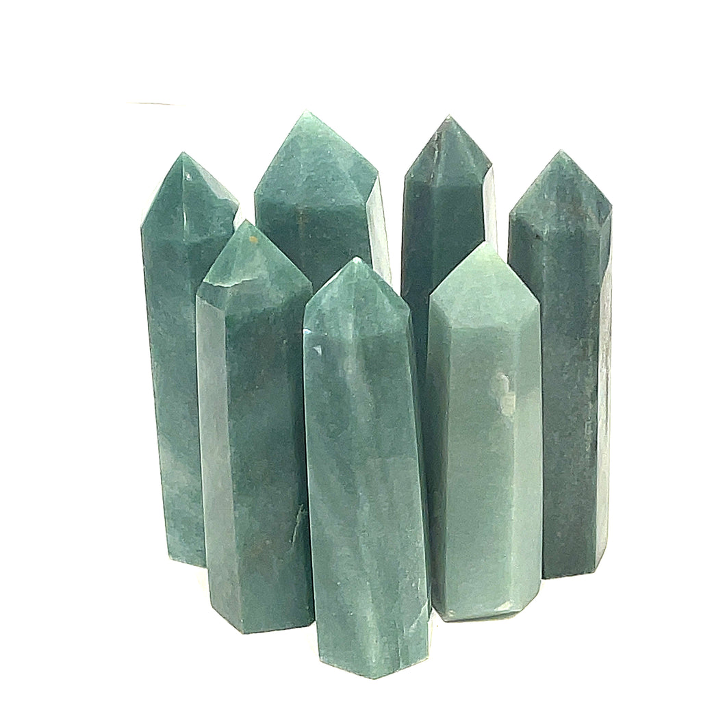 A collection of Green Aventurine Tower Gemstones, pointy and columnar in shape, displayed together on a white background, front view.