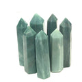 A collection of Green Aventurine Tower Gemstones, pointy and columnar in shape, displayed together on a white background, front view.