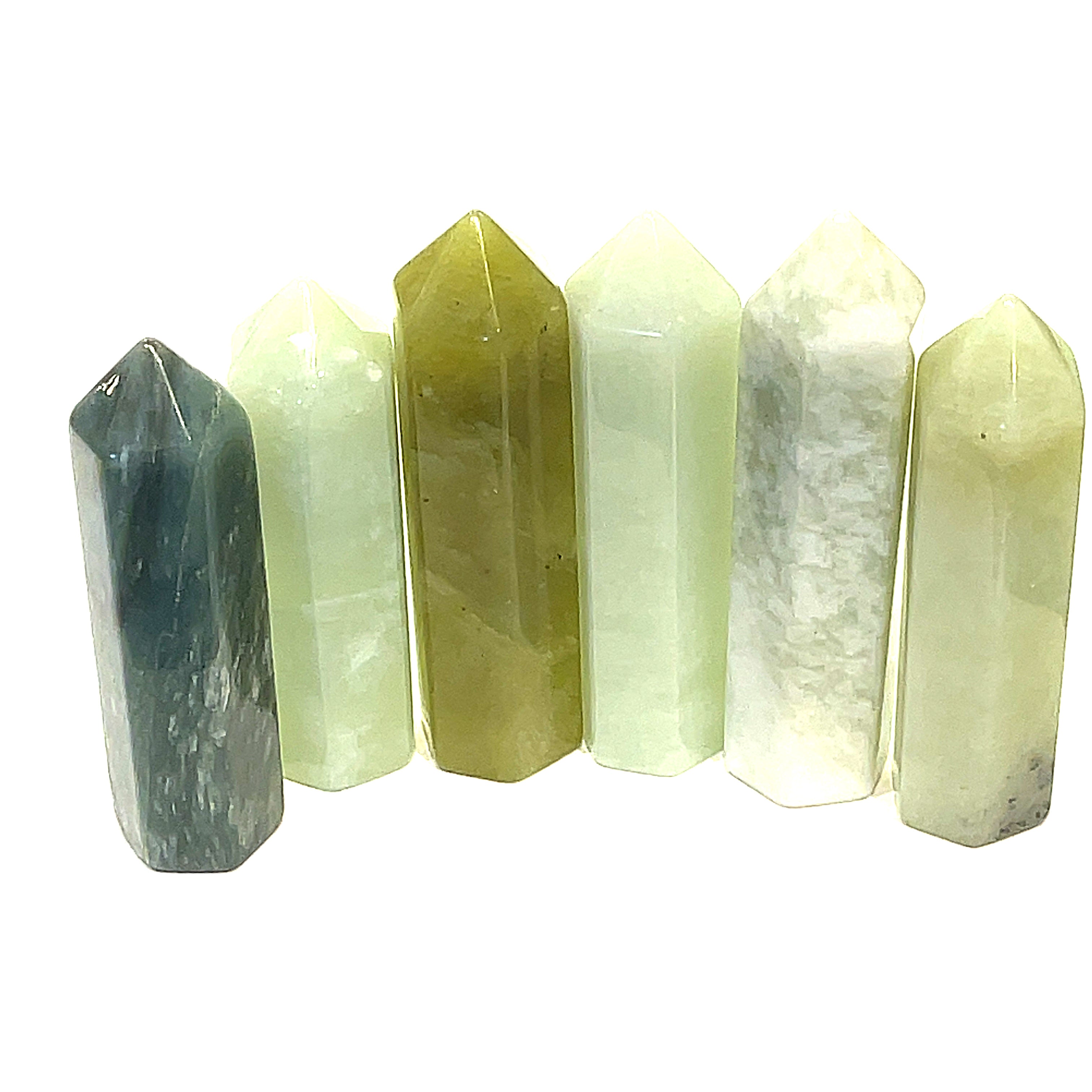 A collection of Green Jade Gemstone Towers displayed in a gradient of green shades, each with a hexagonal shape and pointed top on a white background, front view. 