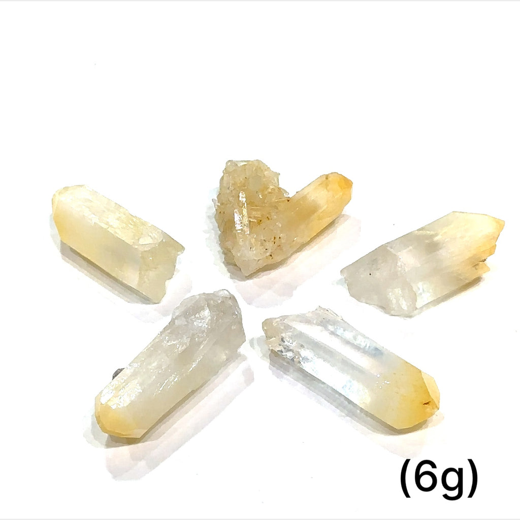 A collection of Halloysite-Included Quartz gemstones, also known as 'Mango Quartz', sizes (6g) is displayed on a white surface center overview.