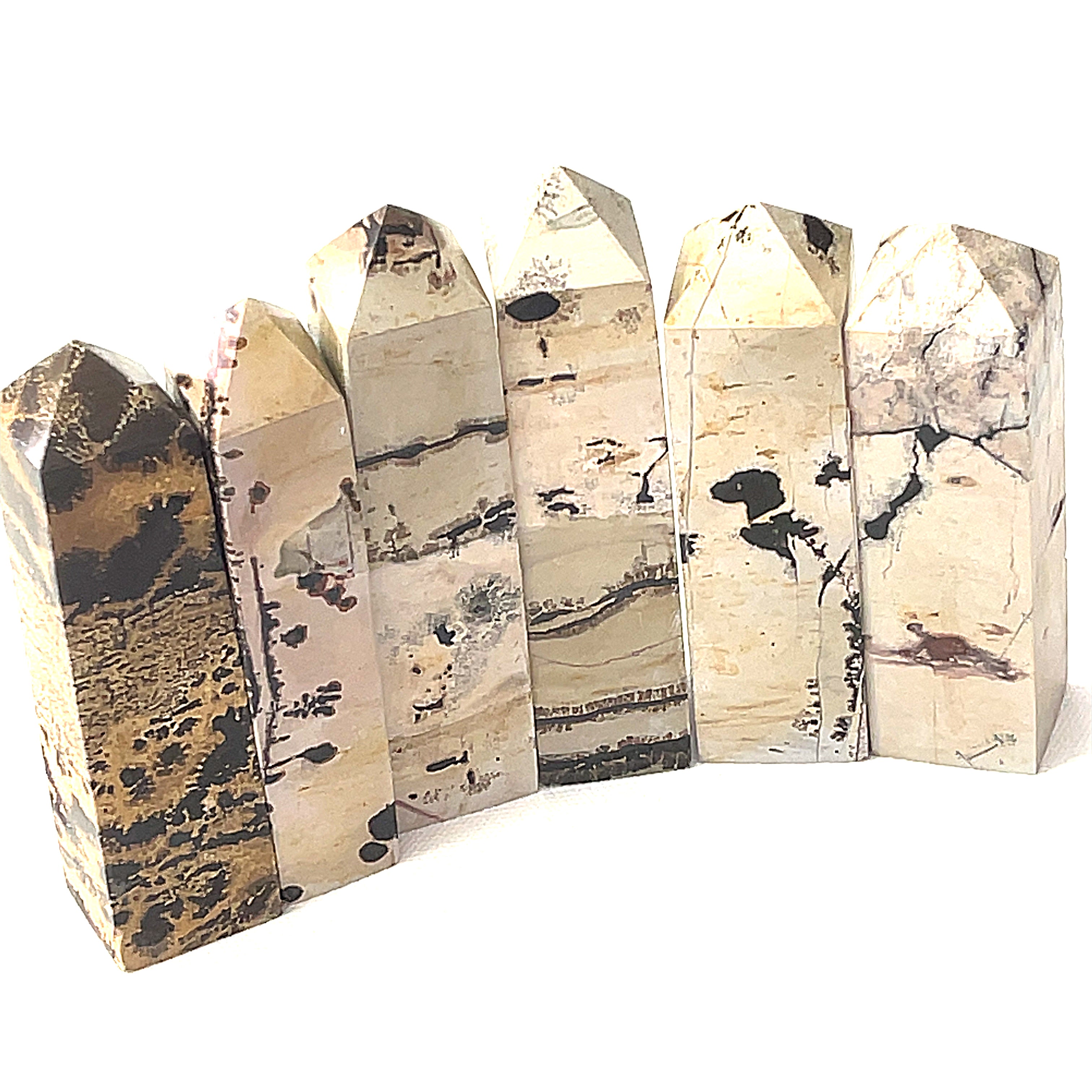 A collection of Picture Jasper gemstone towers arranged in a row, displaying color and pattern variations on a white background, front view. 