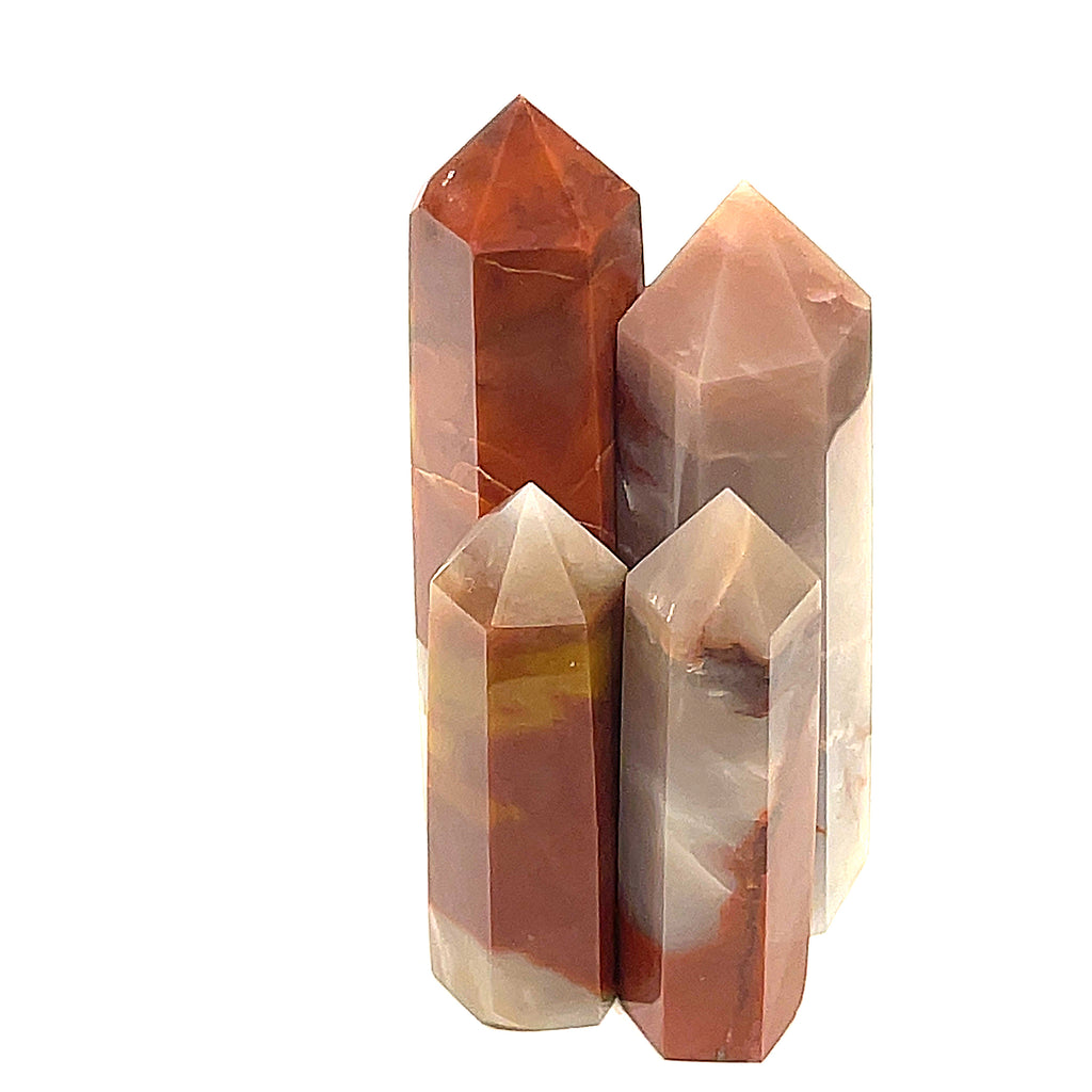 A collection of Red Jasper gemstone towers of varying sizes, arranged vertically, displaying their polished, rectangular faceted shapes and translucent red coloring on a white background front view.