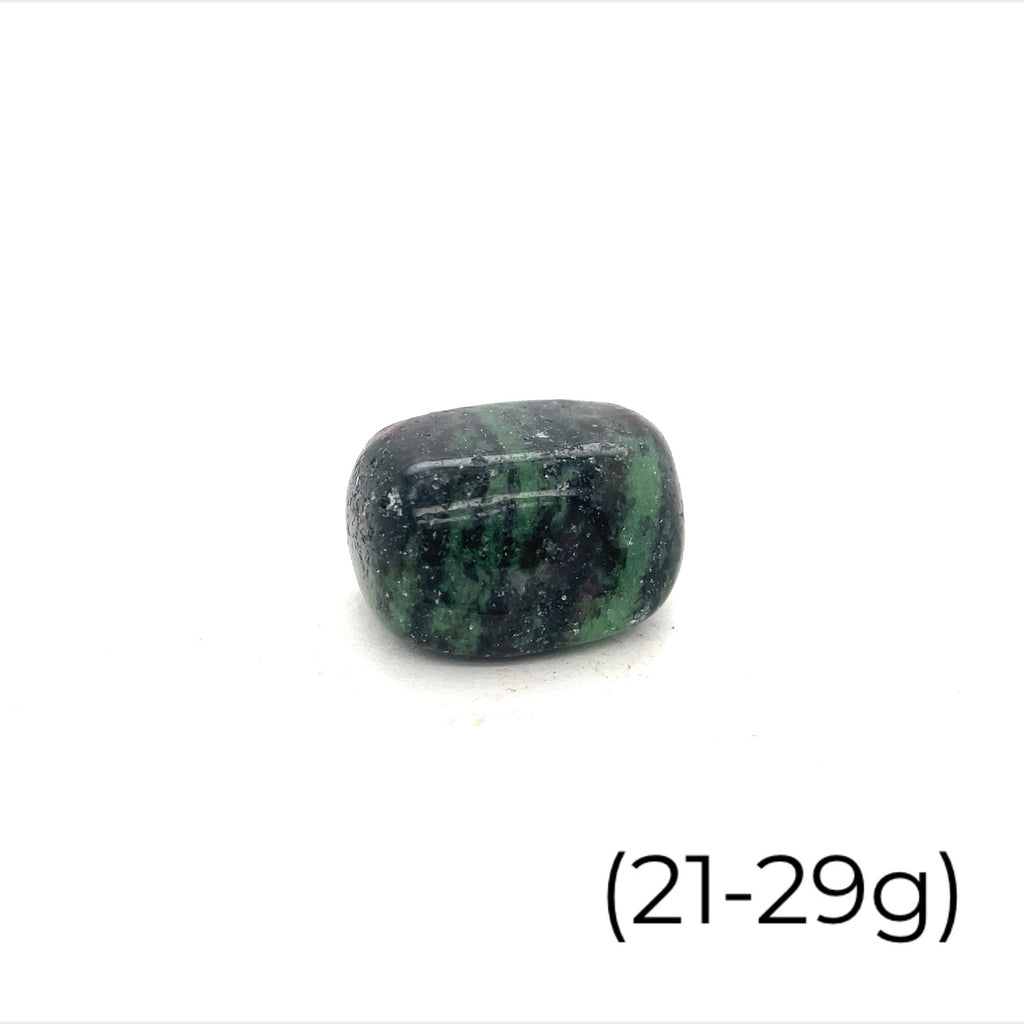 A collection of Ruby in Zoisite tumbled gemstones varying in shades of green with hints of purple, displayed on a white surface. The size of the stones is indicated as 21-29 grams.
