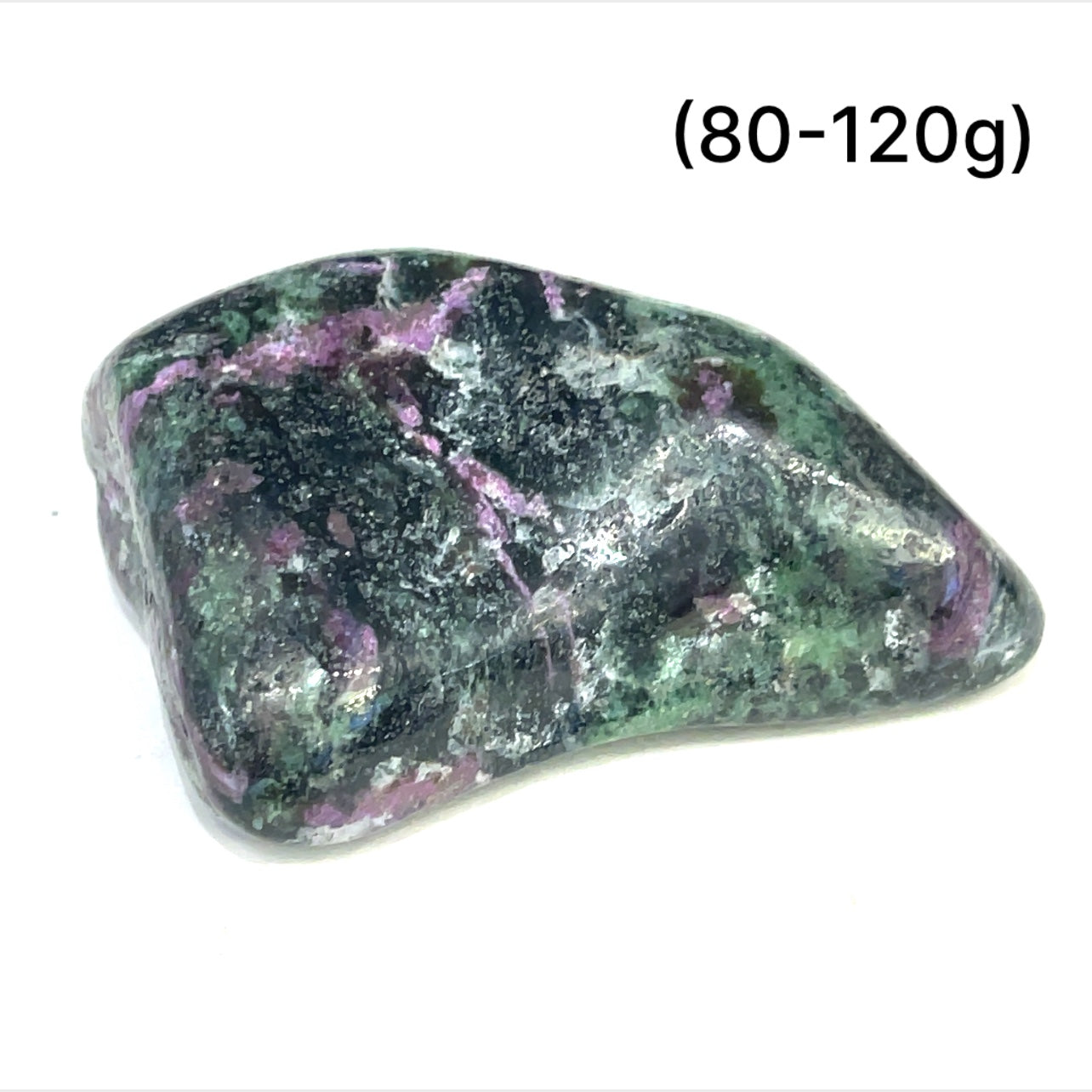 A collection of Ruby in Zoisite tumbled gemstones varying in shades of green with hints of purple, displayed on a white surface. The size of the stones is indicated as 80-120 grams.