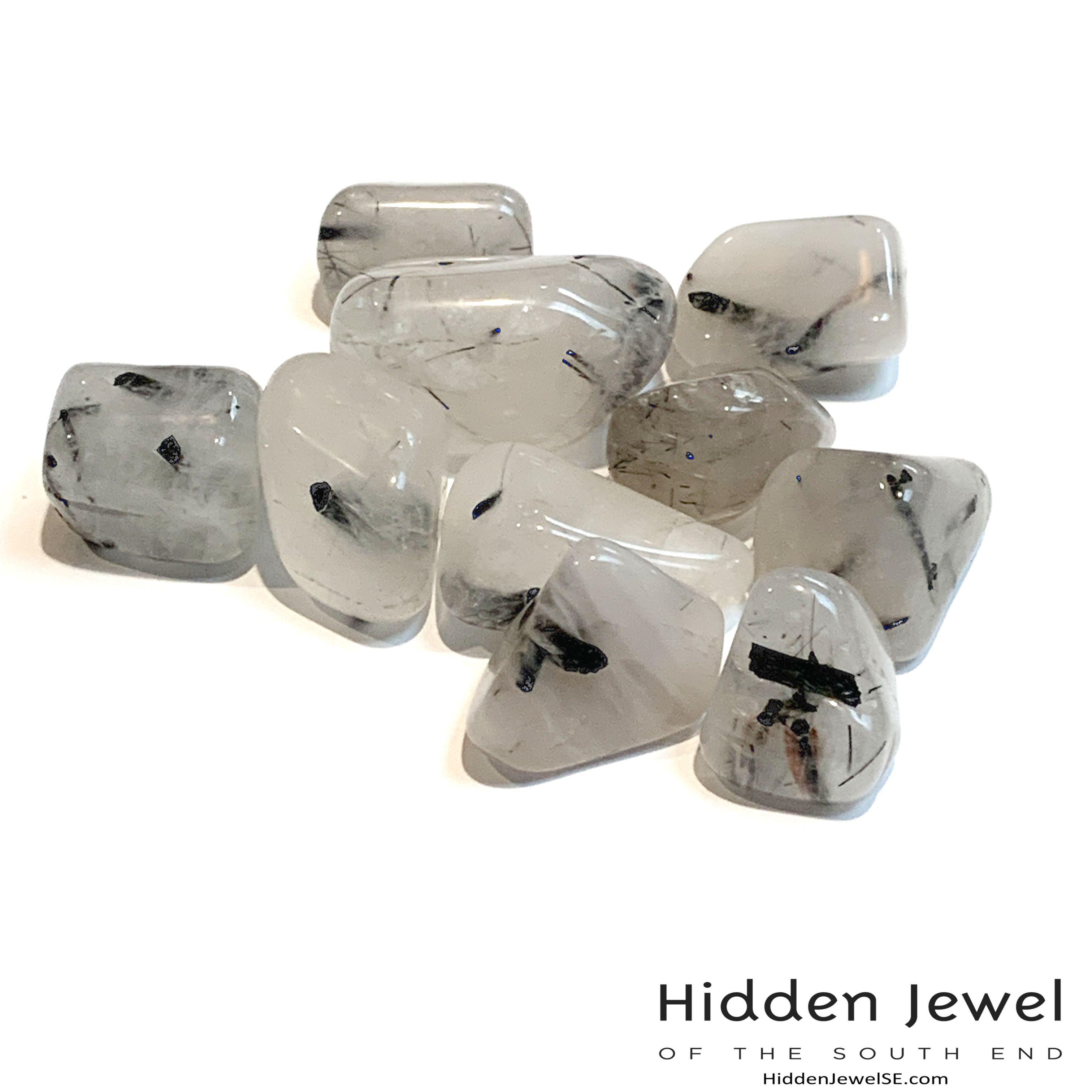A collection of Tourmalinated Quartz tumbled gemstones displayed on a white background, front overview.