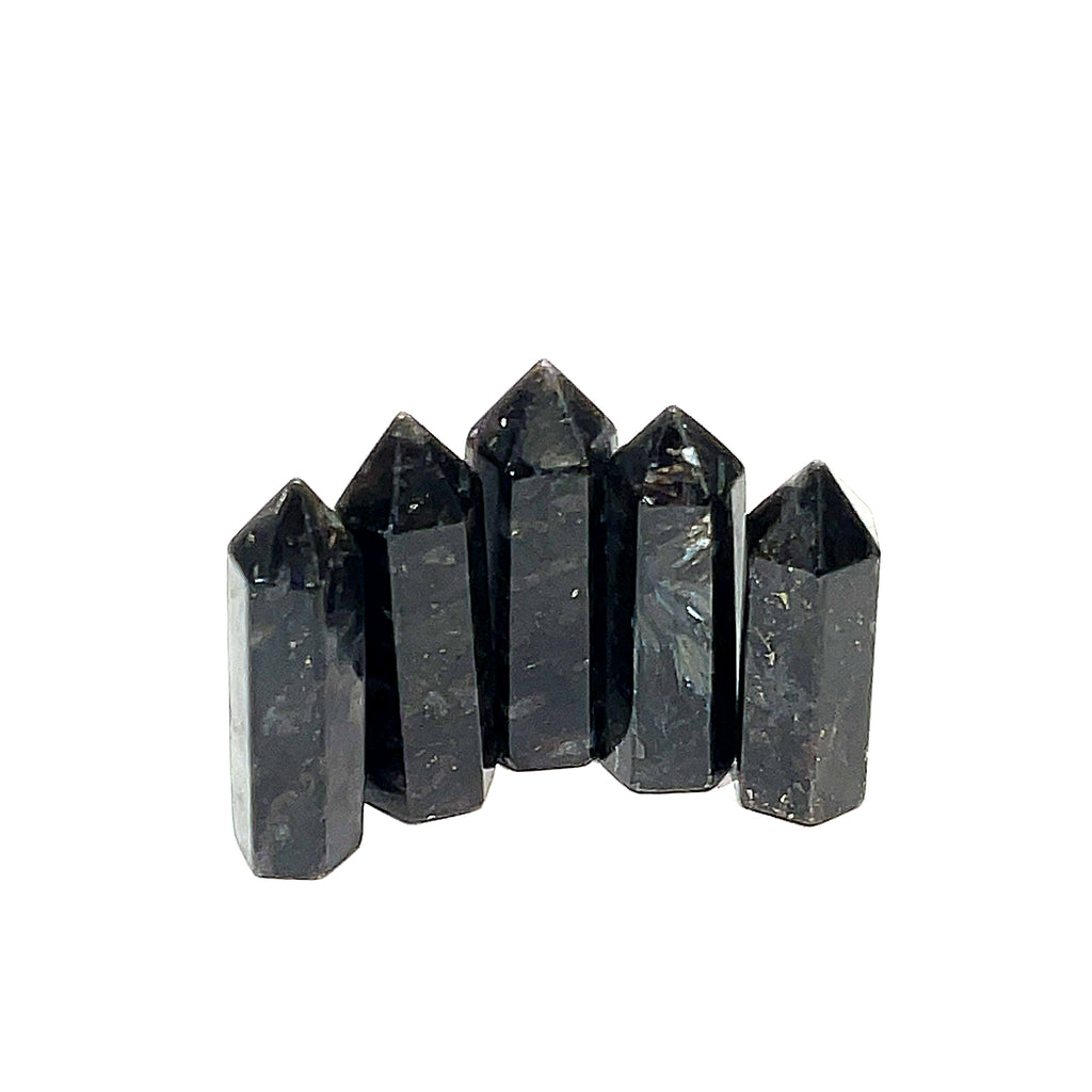 A collection of five black Arfvedsonite gemstone towers arranged together on a white background, front, close up view. 
