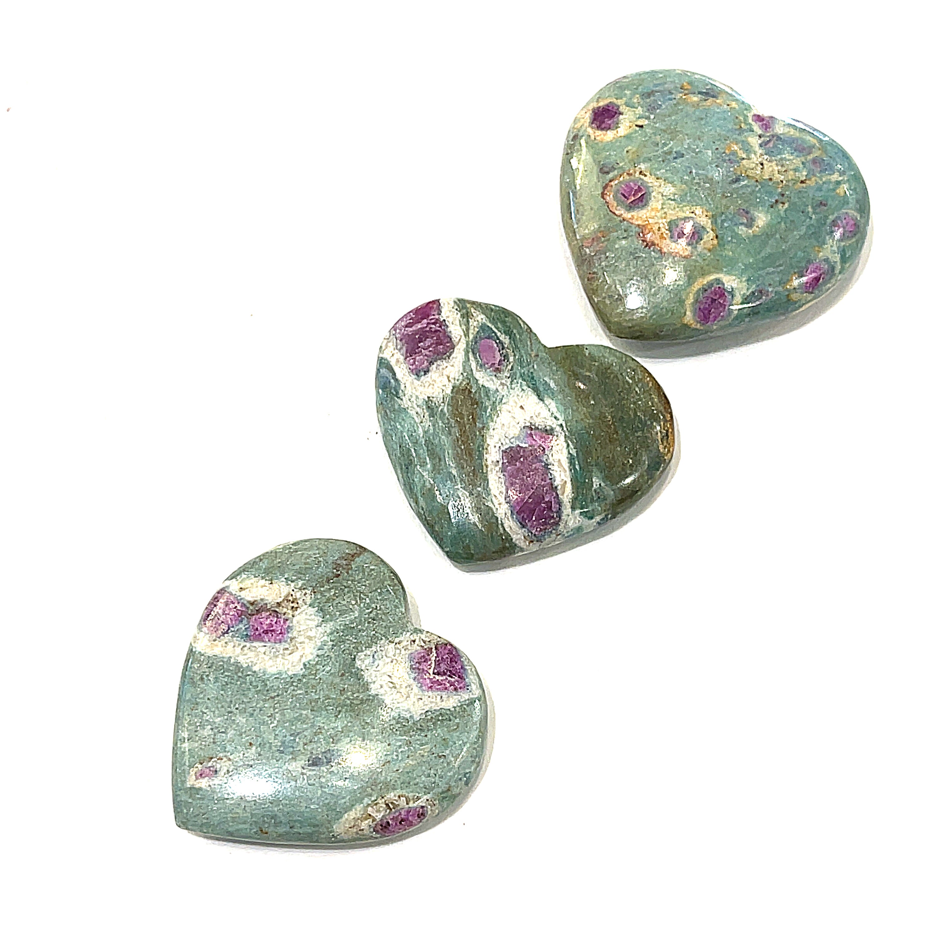 A collection of heart-shaped Ruby Fuchsite gemstone carvings displayed in on a white background front overview.