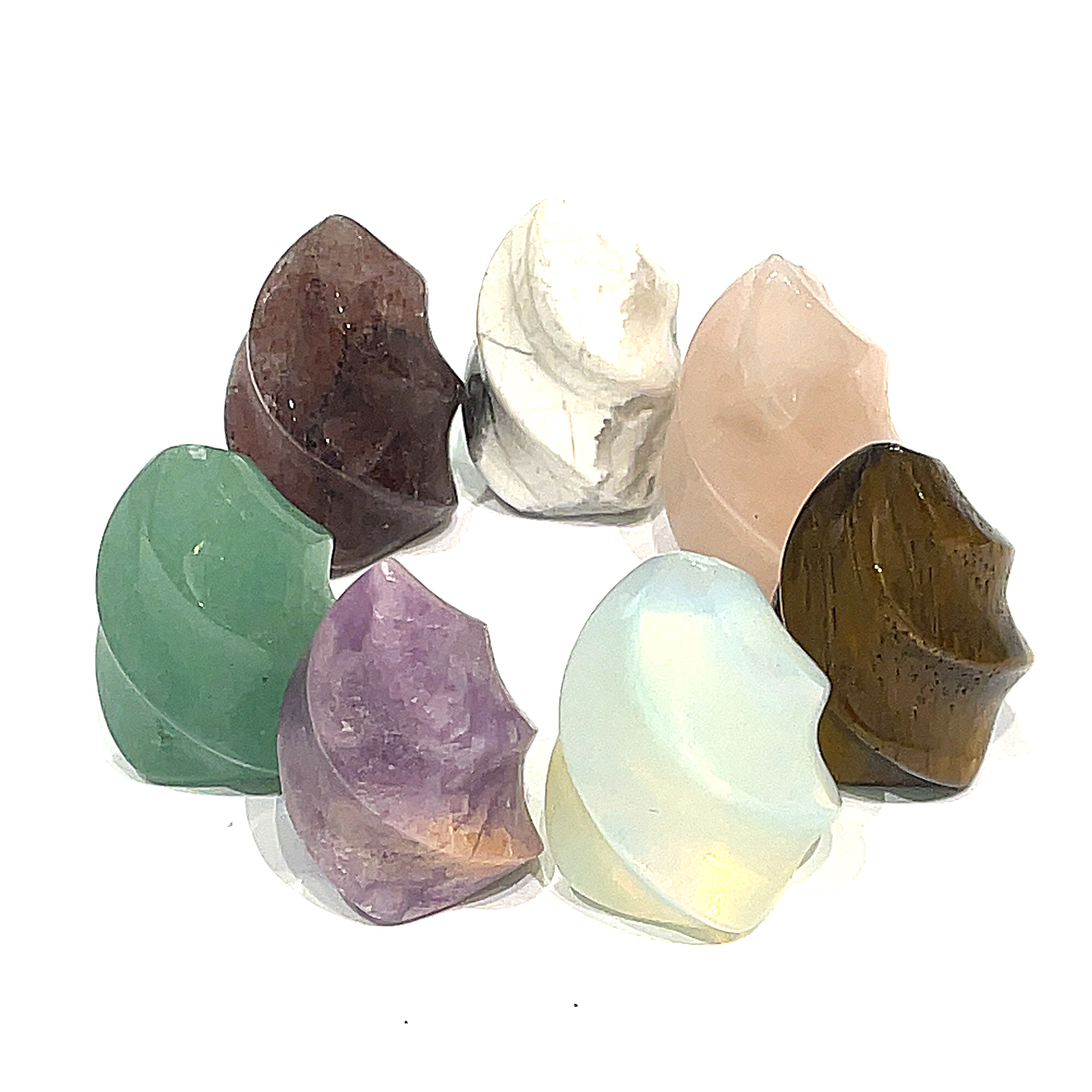 A collection of mini gemstone flames displayed on a white surface, featuring a variety of colors including green, purple, pink, and brown. On a white background, front overview. 