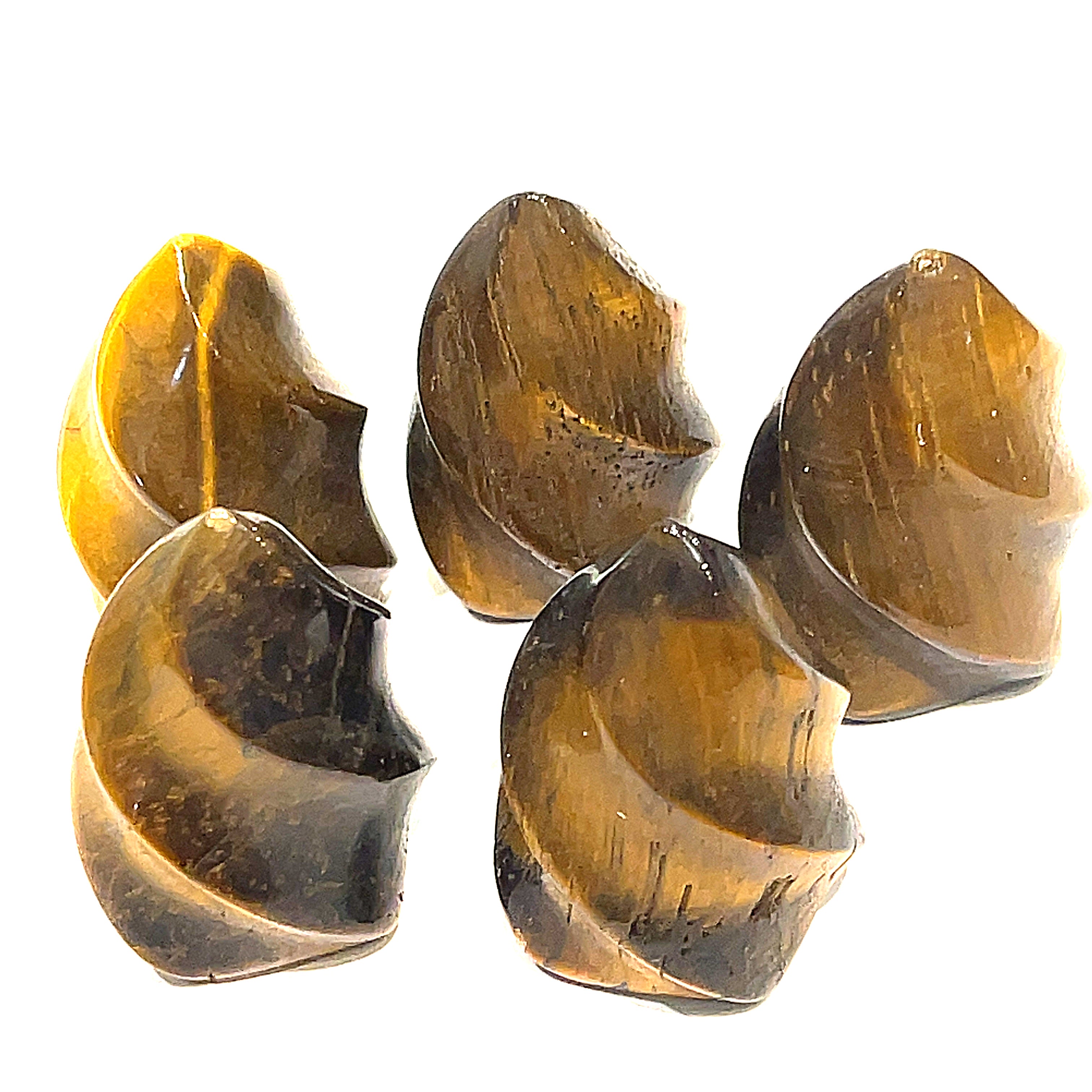 A collection of mini golden tiger eye gemstone flames displayed on a white surface, front overview. 