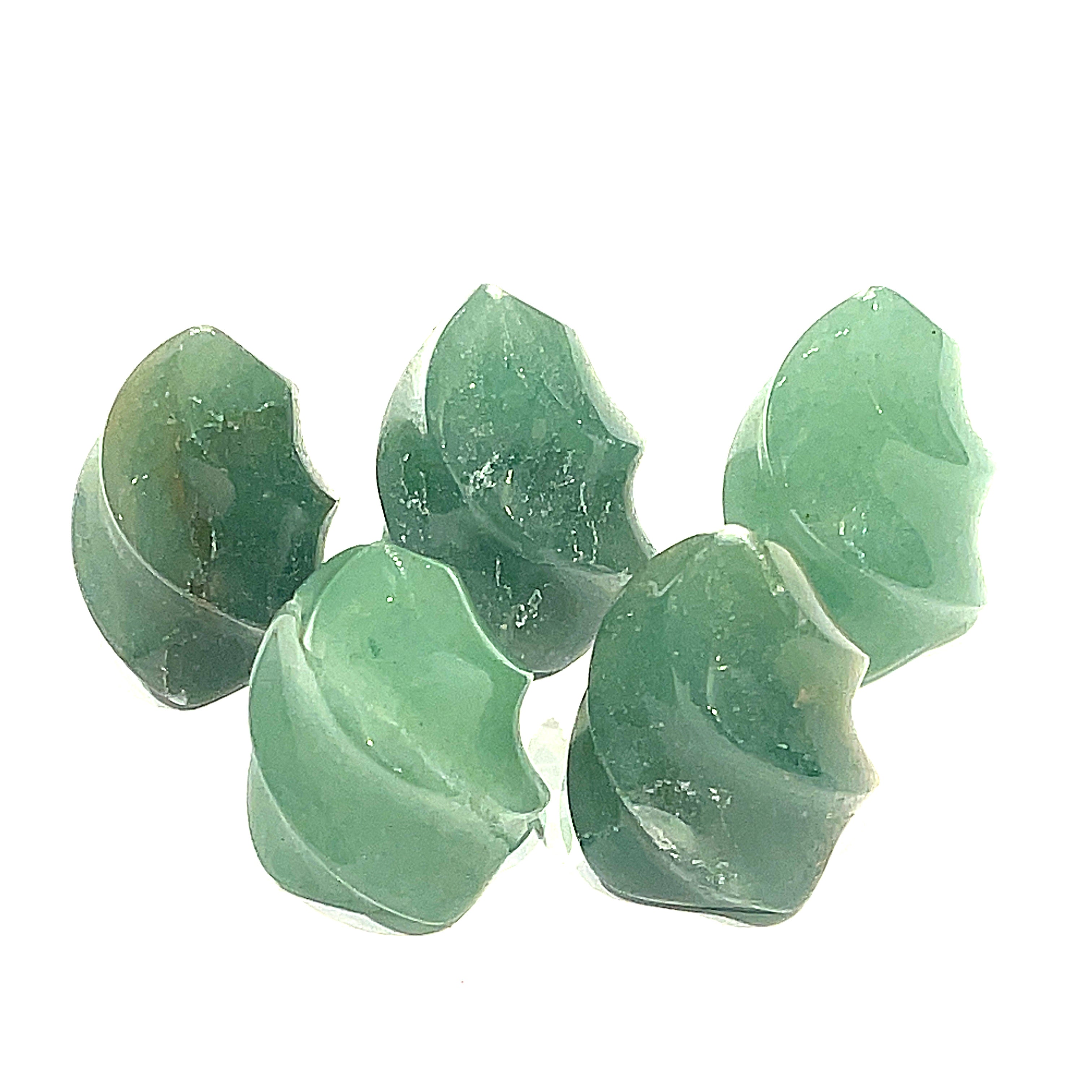 A collection of mini green aventurine gemstone flames displayed on a white surface, front overview. 