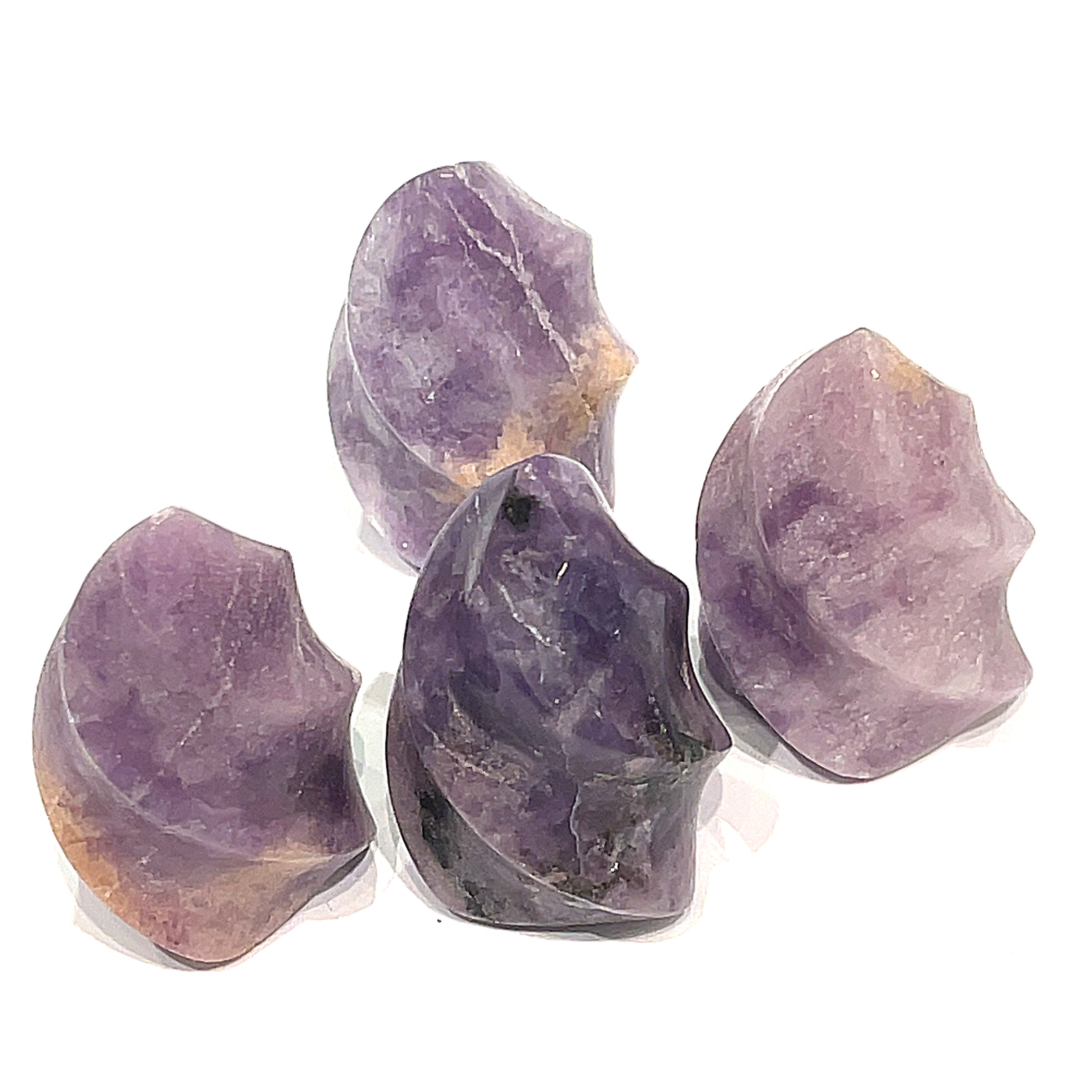 A collection of mini lepidolite gemstone flames displayed on a white surface, front overview. 