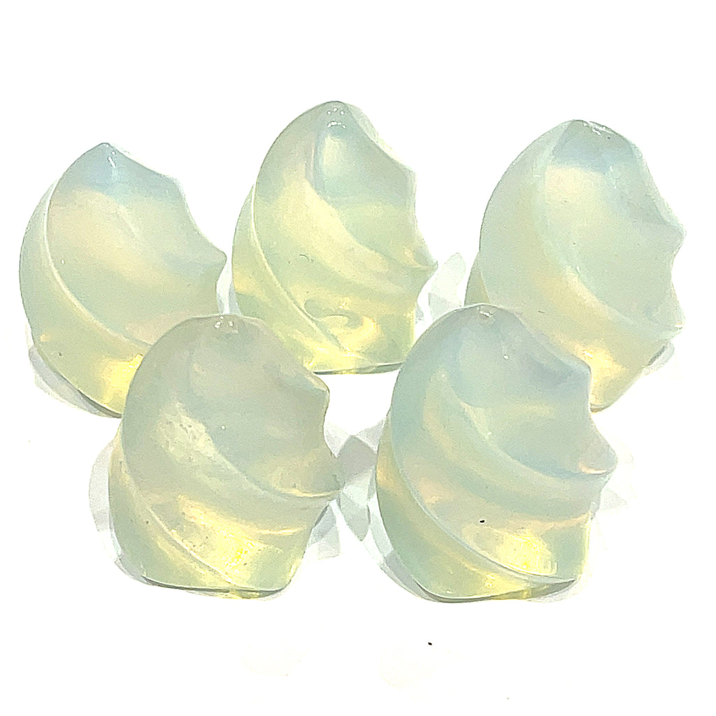 A collection of mini opalite gemstone flames displayed on a white surface, front overview. 