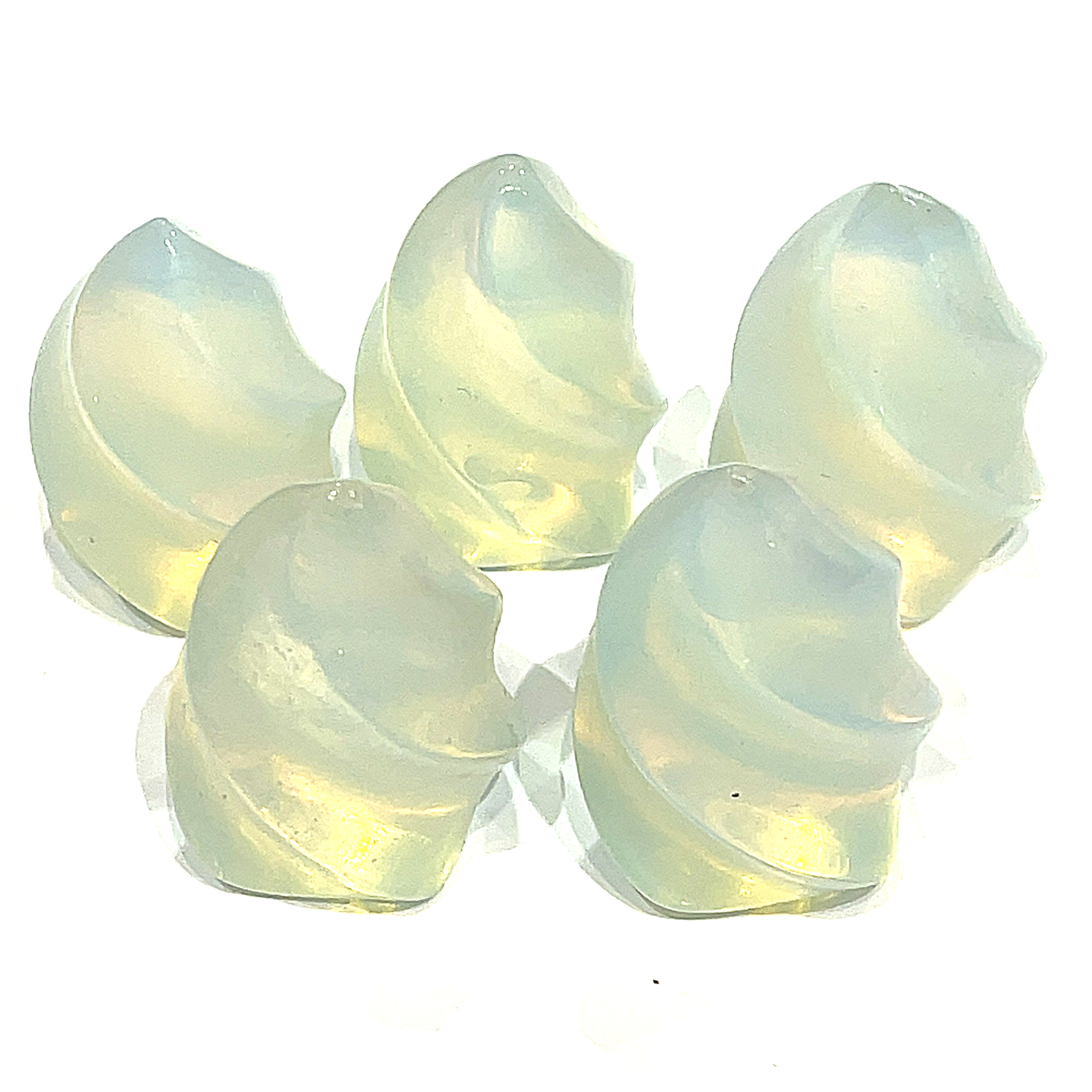 A collection of mini opalite gemstone flames displayed on a white surface, front overview. 