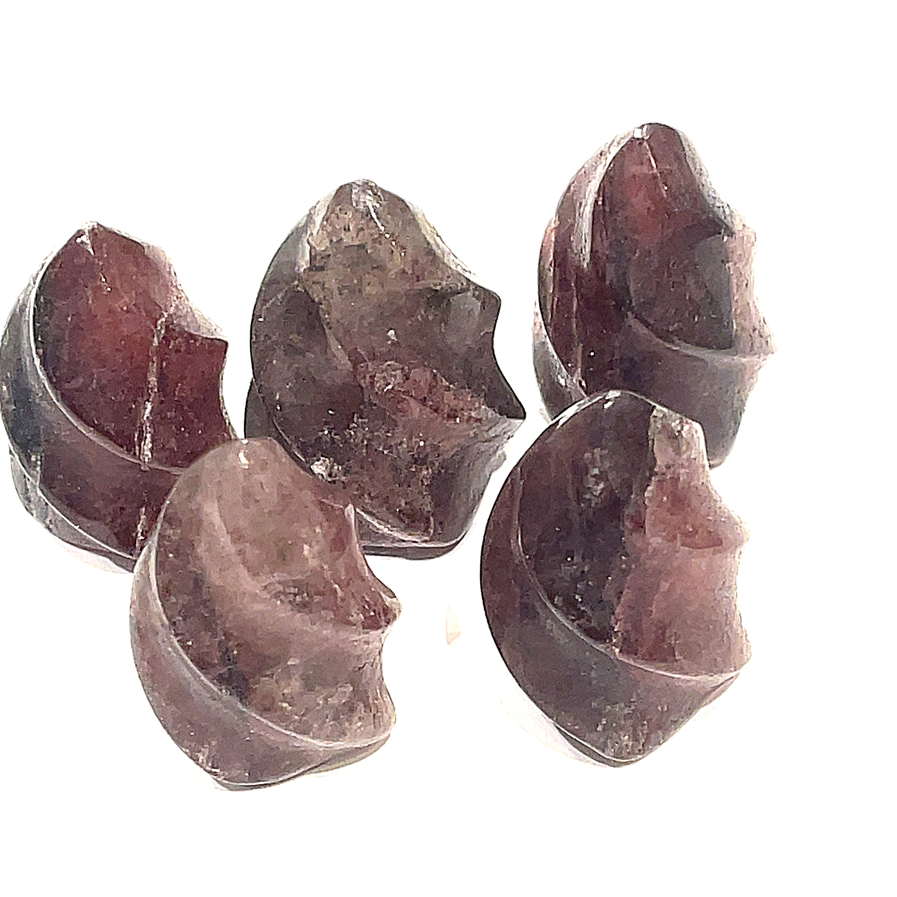A collection of mini strawberry quartz gemstone flames displayed on a white surface, front overview. 