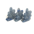 A collection of miniature gemstone carvings in, each resembling a fairy sitting with their hands on their lap, blue Aventruine displayed on a white background, front view. 