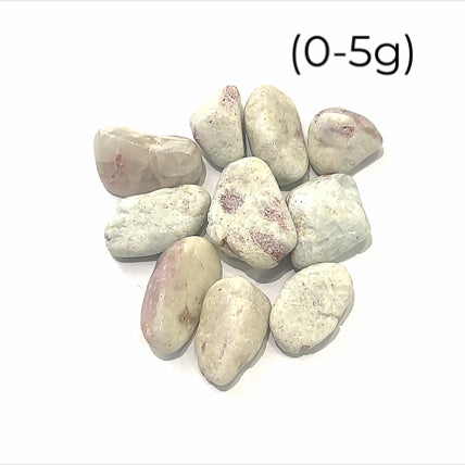 A collection of pink tourmaline in feldspar gemstones with a milky white color and scattered pink inclusions on a white background size (0-5g)
