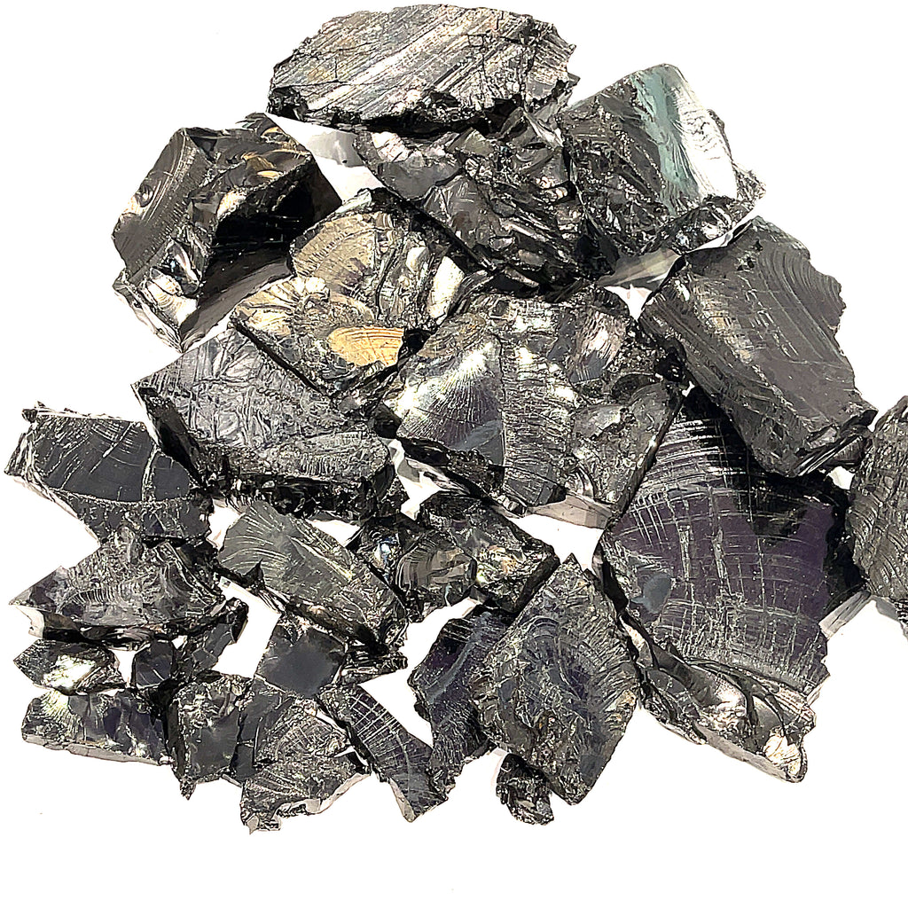 A collection of raw Elite Shungite gemstone chunks on a white background, front overview. 