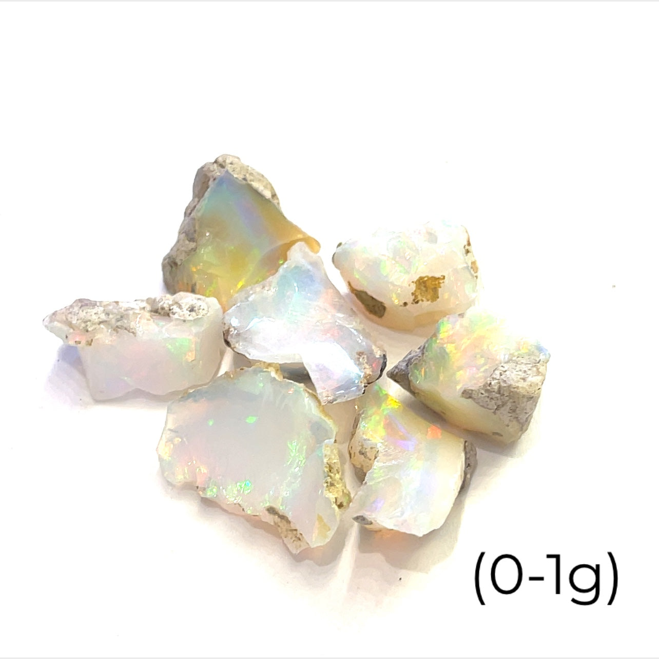 A collection of raw Ethiopian white opal gemstones displayed on a white background, front overview size (0-1g)