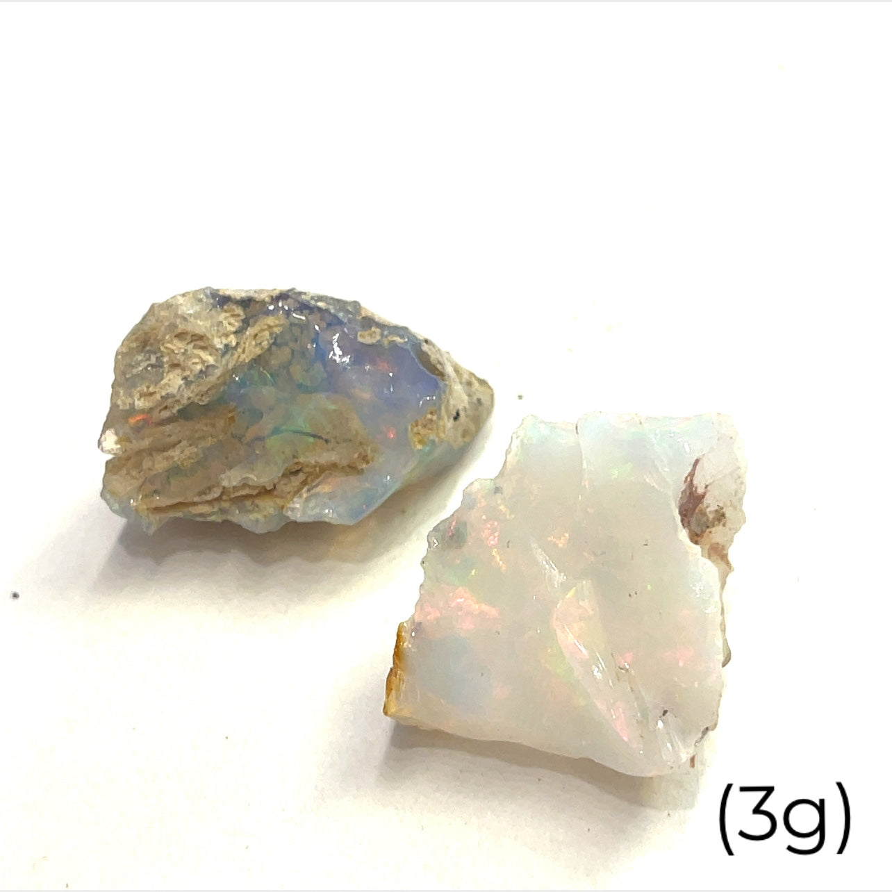 A collection of raw Ethiopian white opal gemstones displayed on a white background, front overview size (3g)