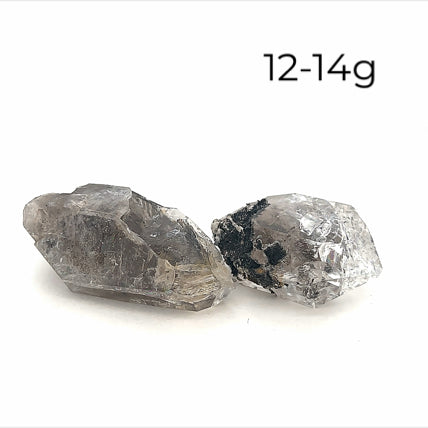 A collection of raw Herkimer diamond gemstones (12-14g) displayed on a white background, front, overview. 