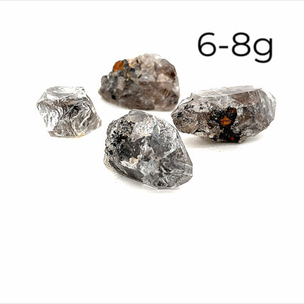 A collection of raw Herkimer diamond gemstones (6-8g) displayed on a white background, front overview. 