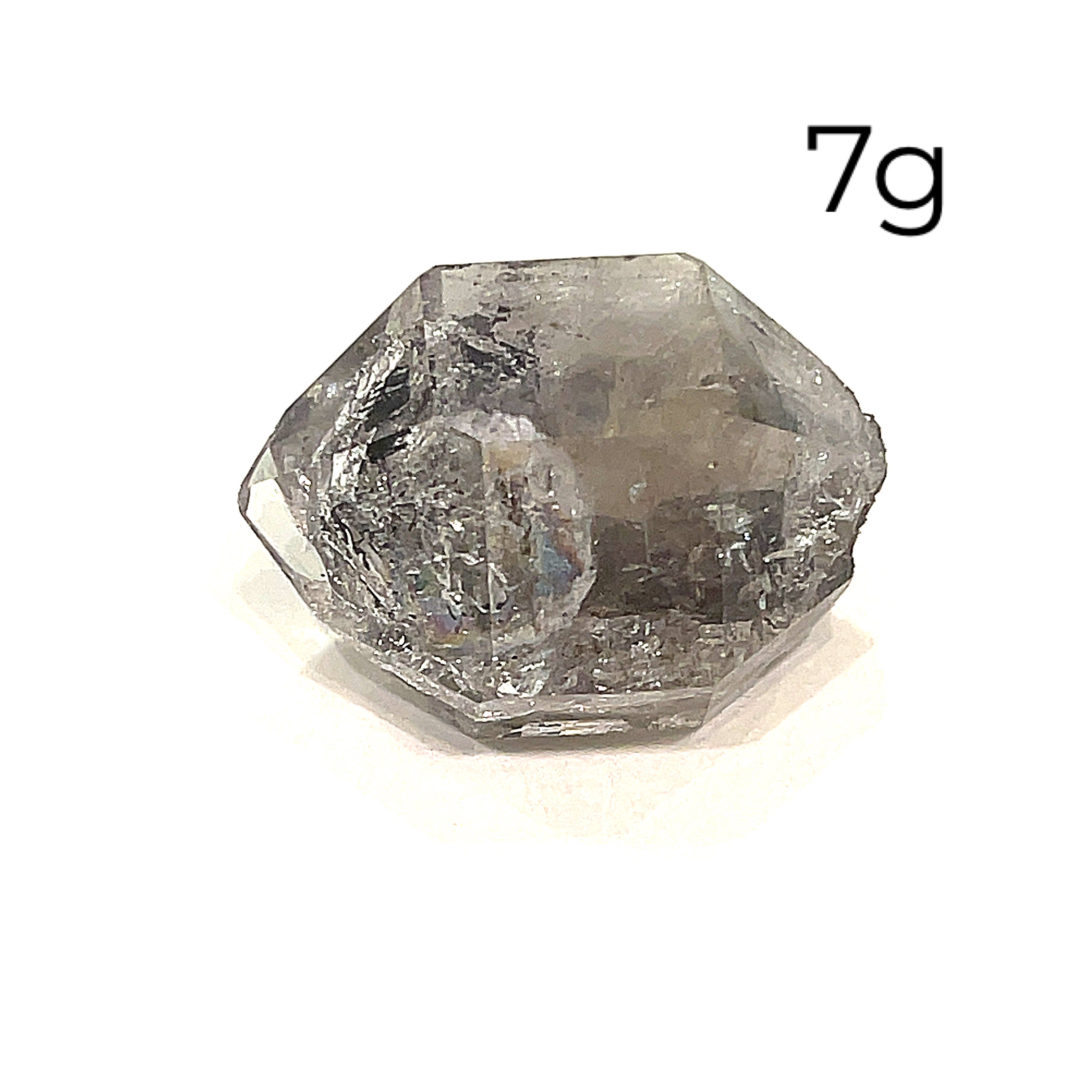 A collection of raw Herkimer diamond gemstones (7g) displayed on a white background, front overview. 