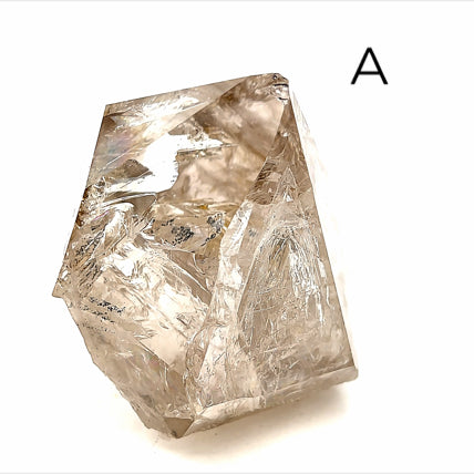 A collection of raw Herkimer diamond gemstones (A) displayed on a white background, side,  overview. 
