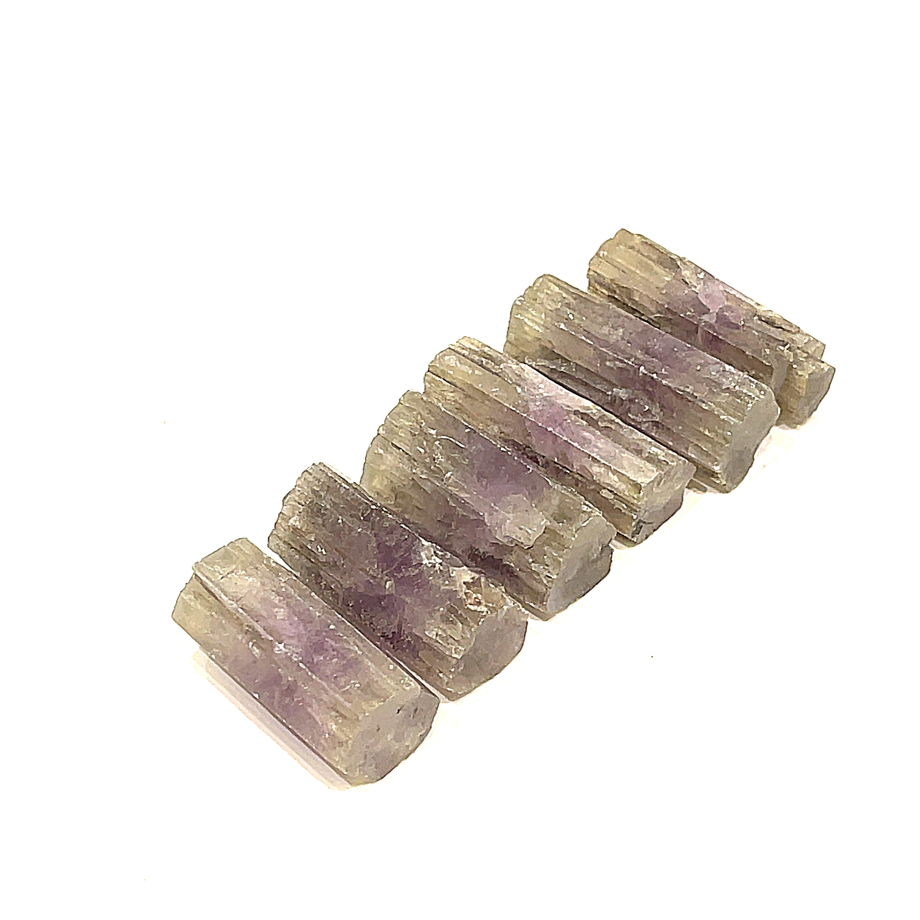 A collection of raw Spanish (Purple) Aragonite gemstones displayed in a row on a white background, front overview.