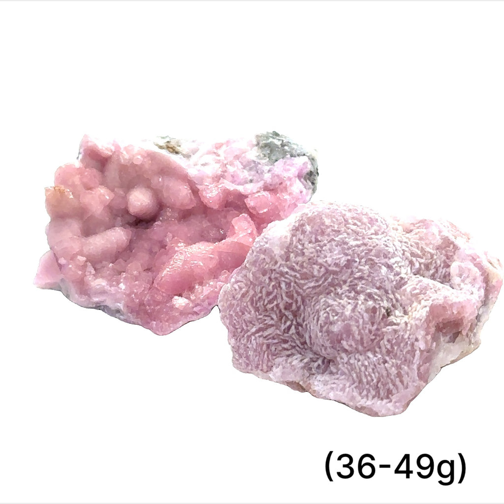 A collection of raw cobalt calcite gemstones with a pinkish hue, showing a rough, unpolished texture, and varying in size. The text indicates the weight range of 36-49 grams. on white background, front view