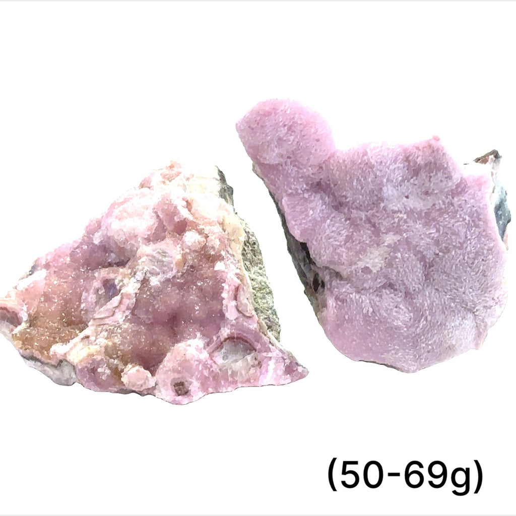 A collection of raw cobalt calcite gemstones with a pinkish hue, showing a rough, unpolished texture, and varying in size. The text indicates the weight range of 50-69 grams. on white background, front view